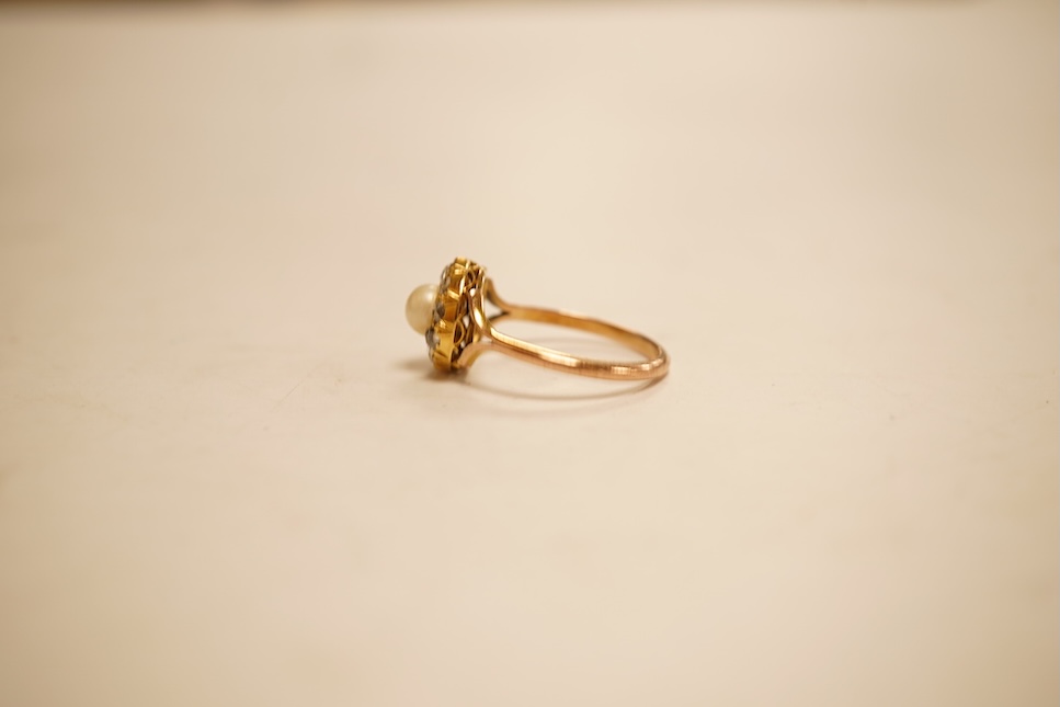 An early 20th century 9ct, cultured pearl and rose cut diamond set circular cluster ring, size O, gross weight 2.8 grams.